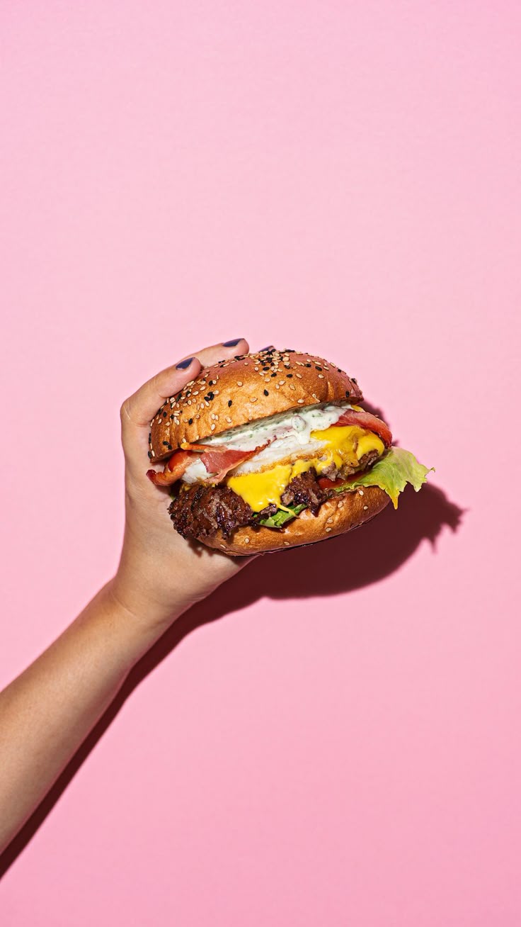 Hand holding hamburger