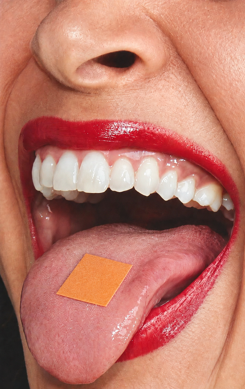 Close-up of a tongue with a melty strip on it