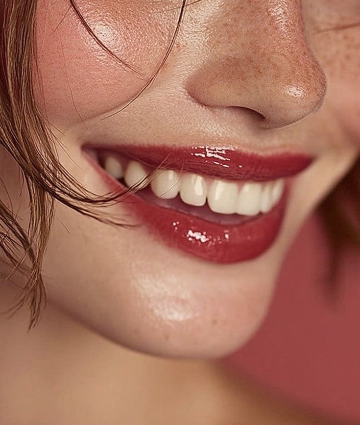 Smiling woman with glossy red lipstick